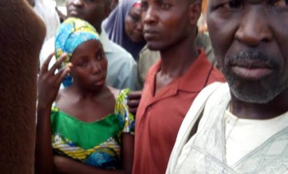 One of the lucky abducted students in Chibok who was later rescued and being handed over by her parents at school premises on Monday. 