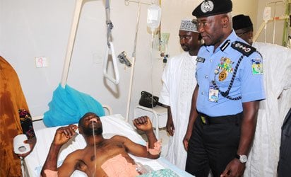 JOS BLAST VICTIM—D-G, National Emergency Management Agency, Muhammed Sidi (L) with Igp Mohammed Abubakar, sympathising with a victim of the Jos bomb blast, at Jos University Teaching Hospital, yesterday. Inset: Another victim at the Plateau Specialist Hospital. Photos: NAN.